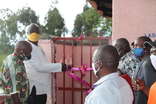 Kabarole district chairperson the Hon. Richard Rwabuhinga cuts the tape to officially open the first sanitation facility at Bwanika Health Centre II