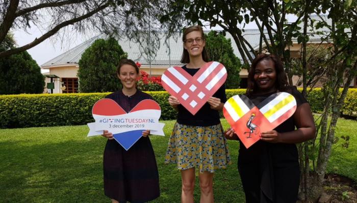 Partners holding Giving Tuesday hearts in Uganda