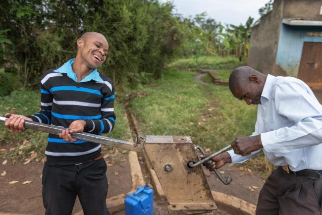 Fixing a hand pump in Fort Portal, Karambole District, Uganda