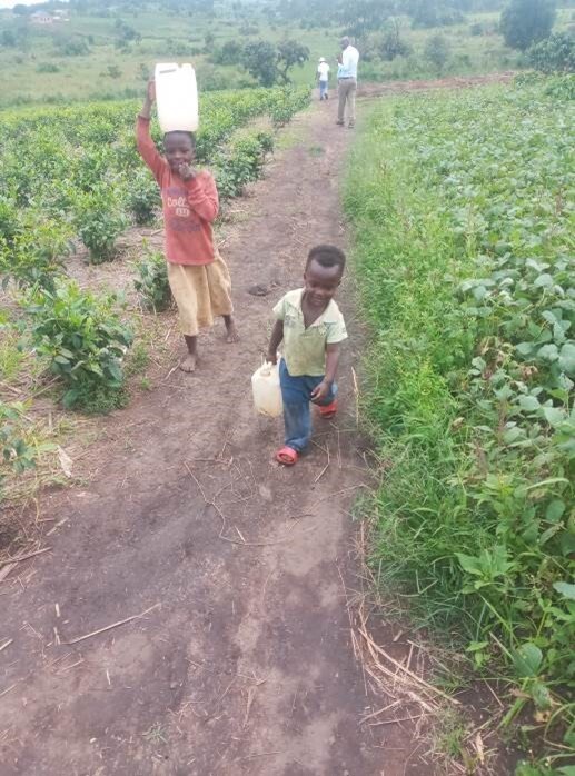 Children return home after fetching dirty water for household use at their home
