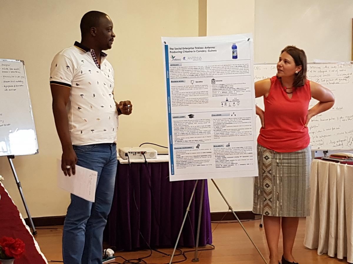 Aboubacar Camara (on the left) presenting during a workshop with Fanny Boulloud (on the right)