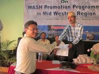 Mr Bimal Tandukar receives a letter of appreciation on behalf of SNV  from Dr. Dhan Raj Ratala, Regional Administrator, for their contribution to sanitation and hygiene promotion in Mid-West Region in Nepal.